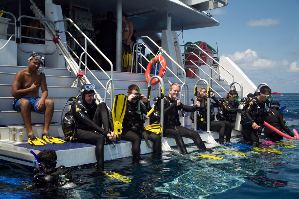 Divers sitting on the back deck of SeaQuest